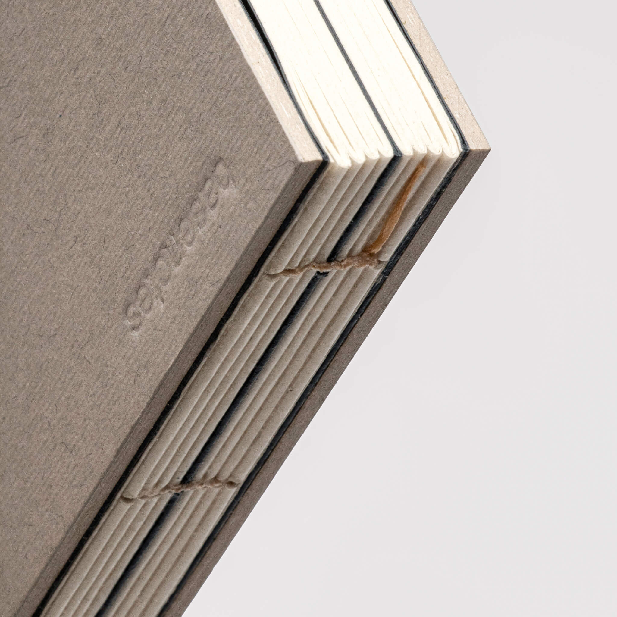 Close-up of basenotes 1623 Paperbook showing exposed hand-stitched binding and eco-friendly paper.