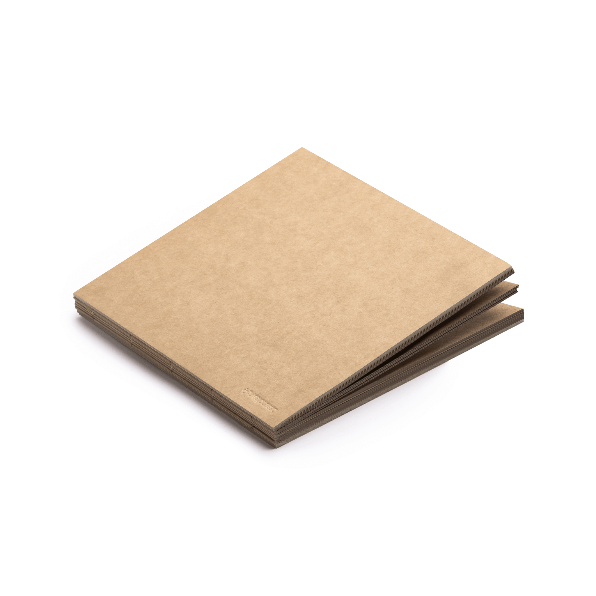Closed square paperbook in 22 × 22 cm format, made with natural kraft paper and hand-sewn binding