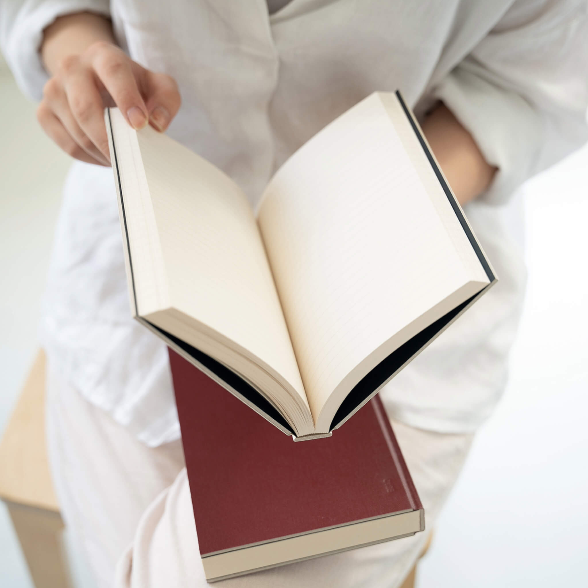 Open basenotes 0128 Notebook held in hand, showing smooth lined pages and lay-flat binding.