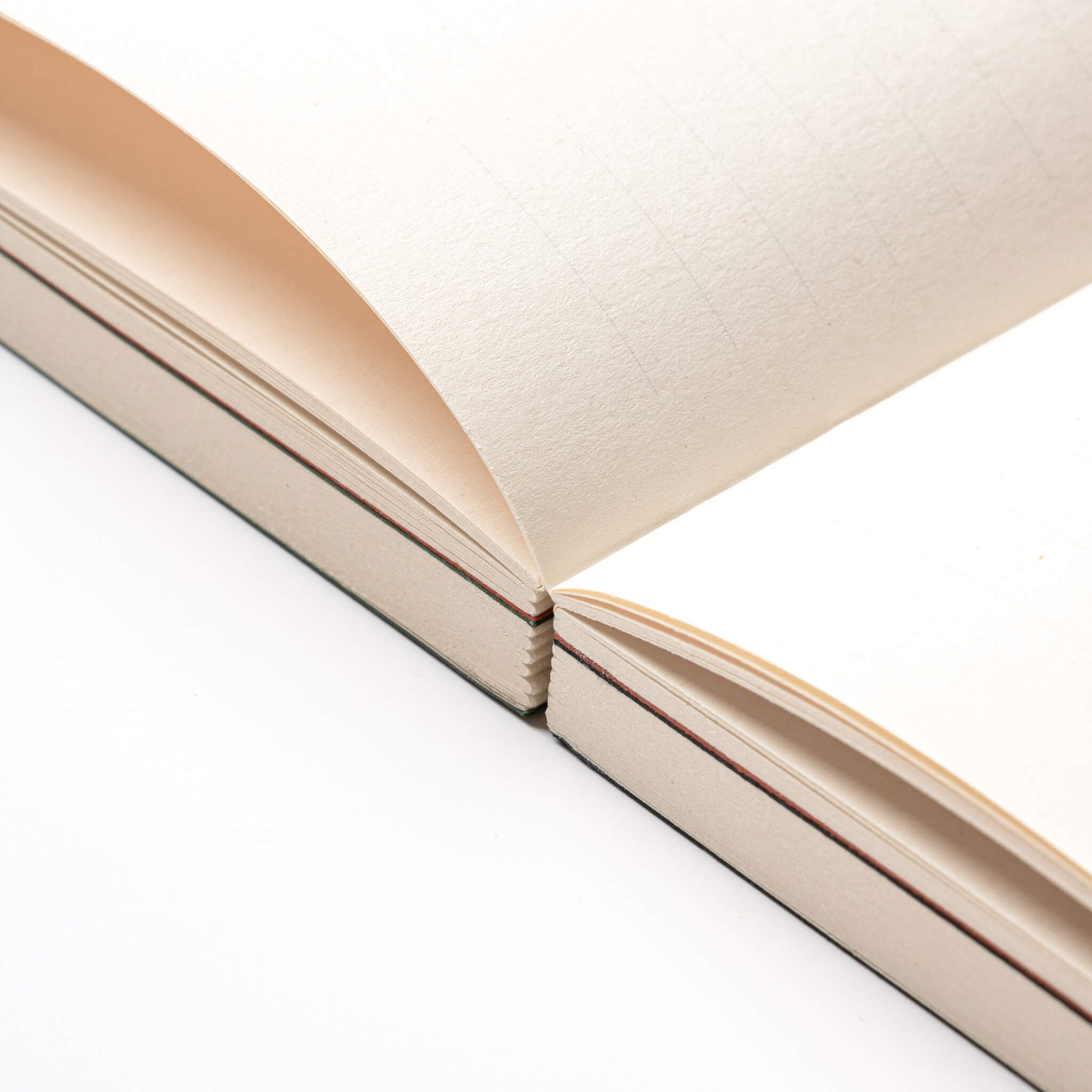Close-up of basenotes 0144 Notebook showing thread-sewn exposed binding that allows pages to open fully flat.