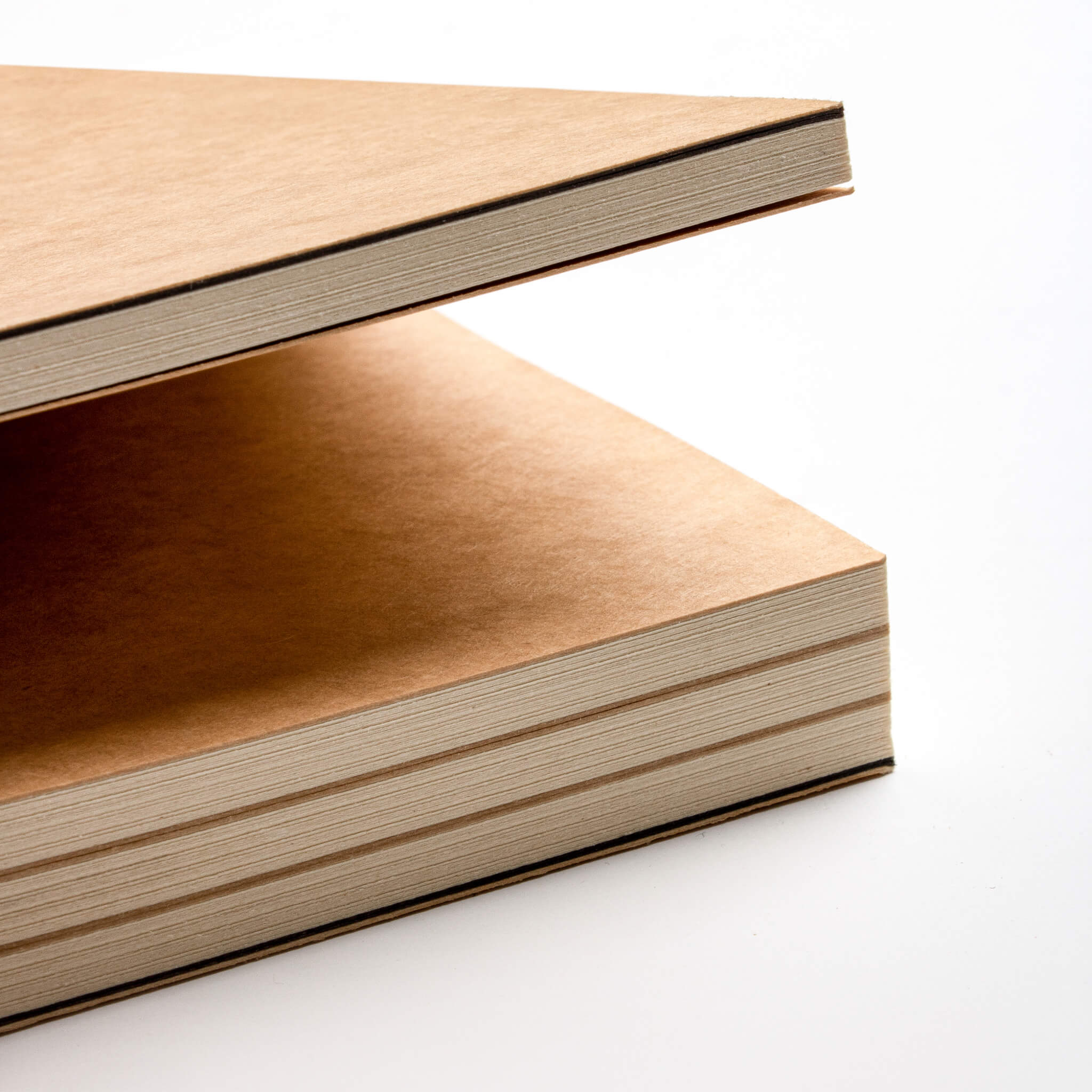 Close-up of the kraft cover and edge of the basenotes 0432 Notebook, showing layered paper sections.