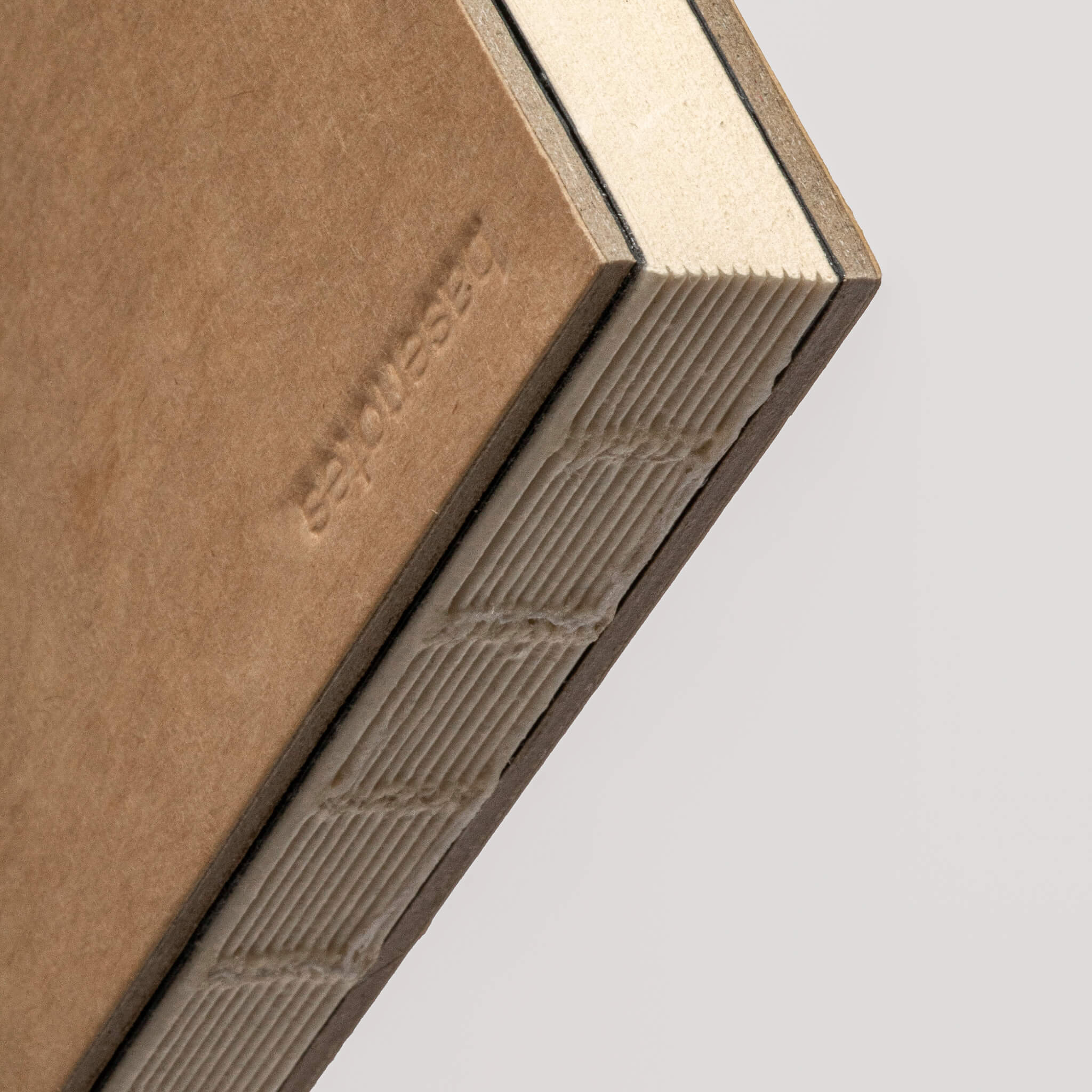 Close-up of the basenotes 0880 Notebook’s embossed logo and exposed binding, showing fine craftsmanship.