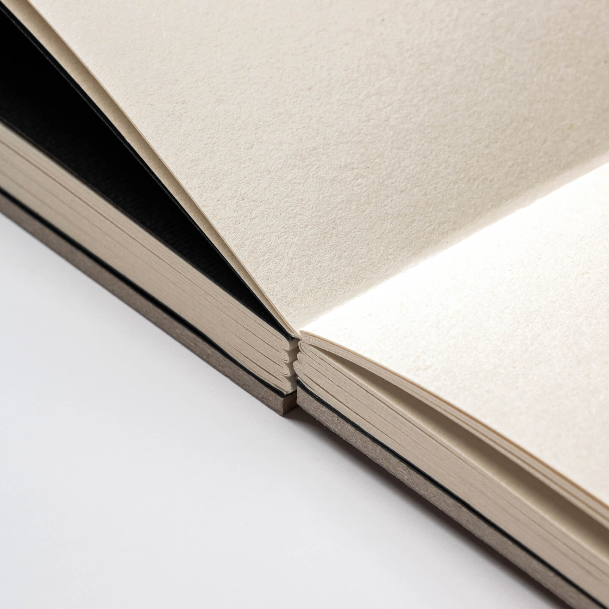 Open basenotes 1623 Paperbook in beige with lay-flat binding, revealing acid-free eco-friendly paper.
