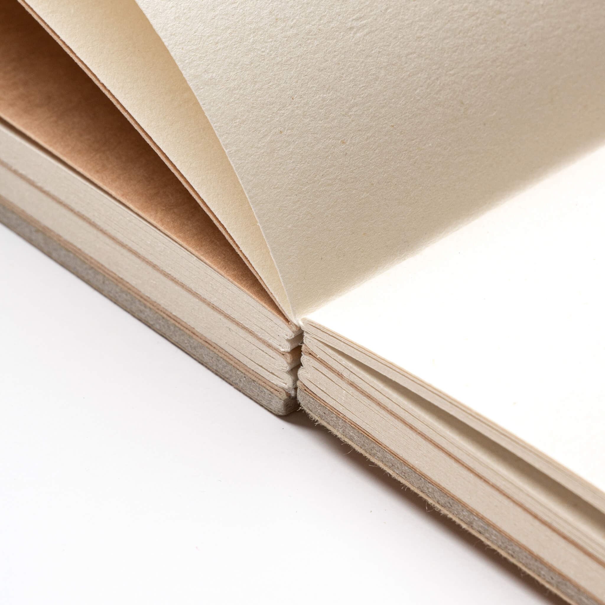 Open 2222 basenotes Paperbook showing hand-stitched spine, eco-friendly kraft paper, and lay-flat design for smooth use.