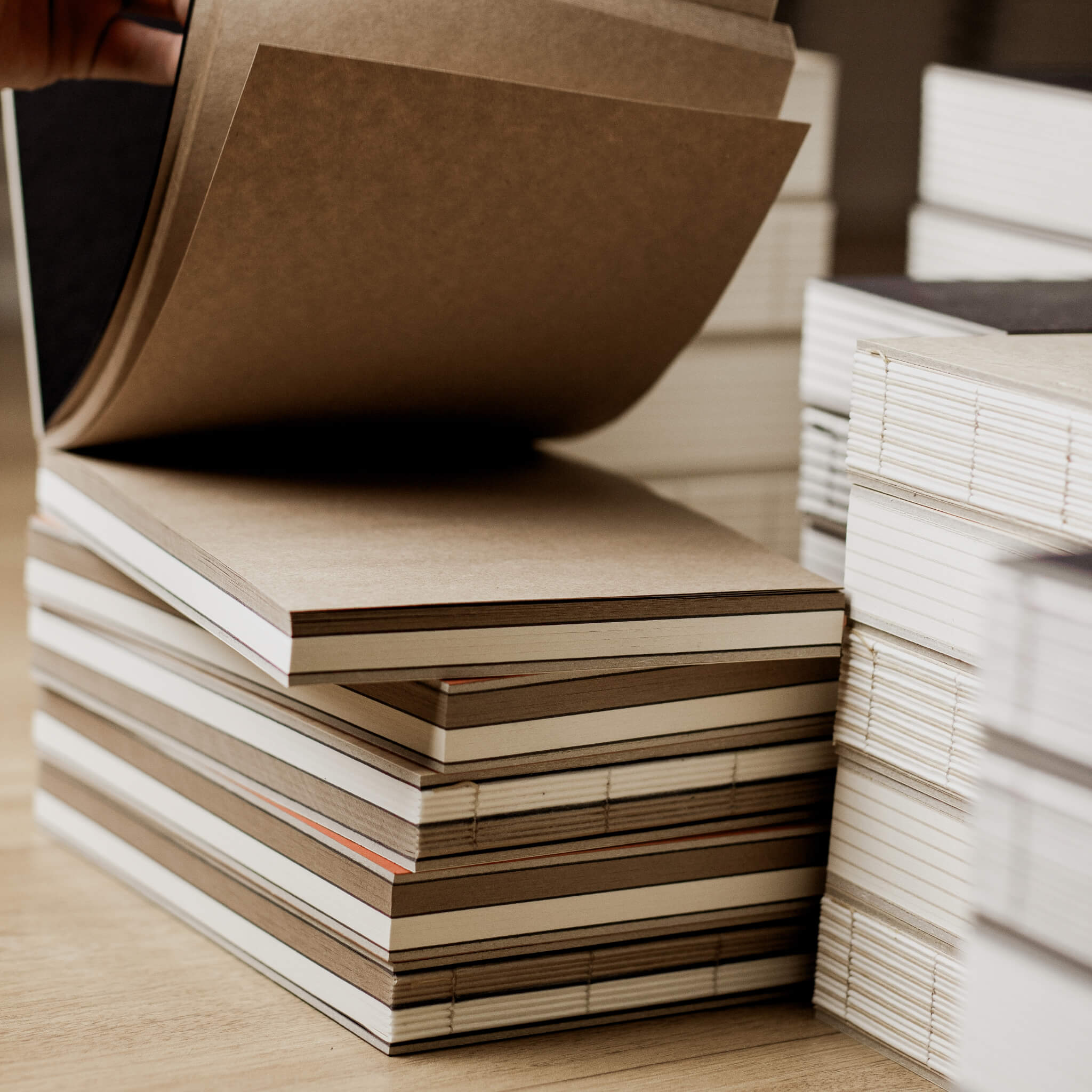 basenotes 2316M Paper books in a workshop setting, showing open Kraft section and visible spines.