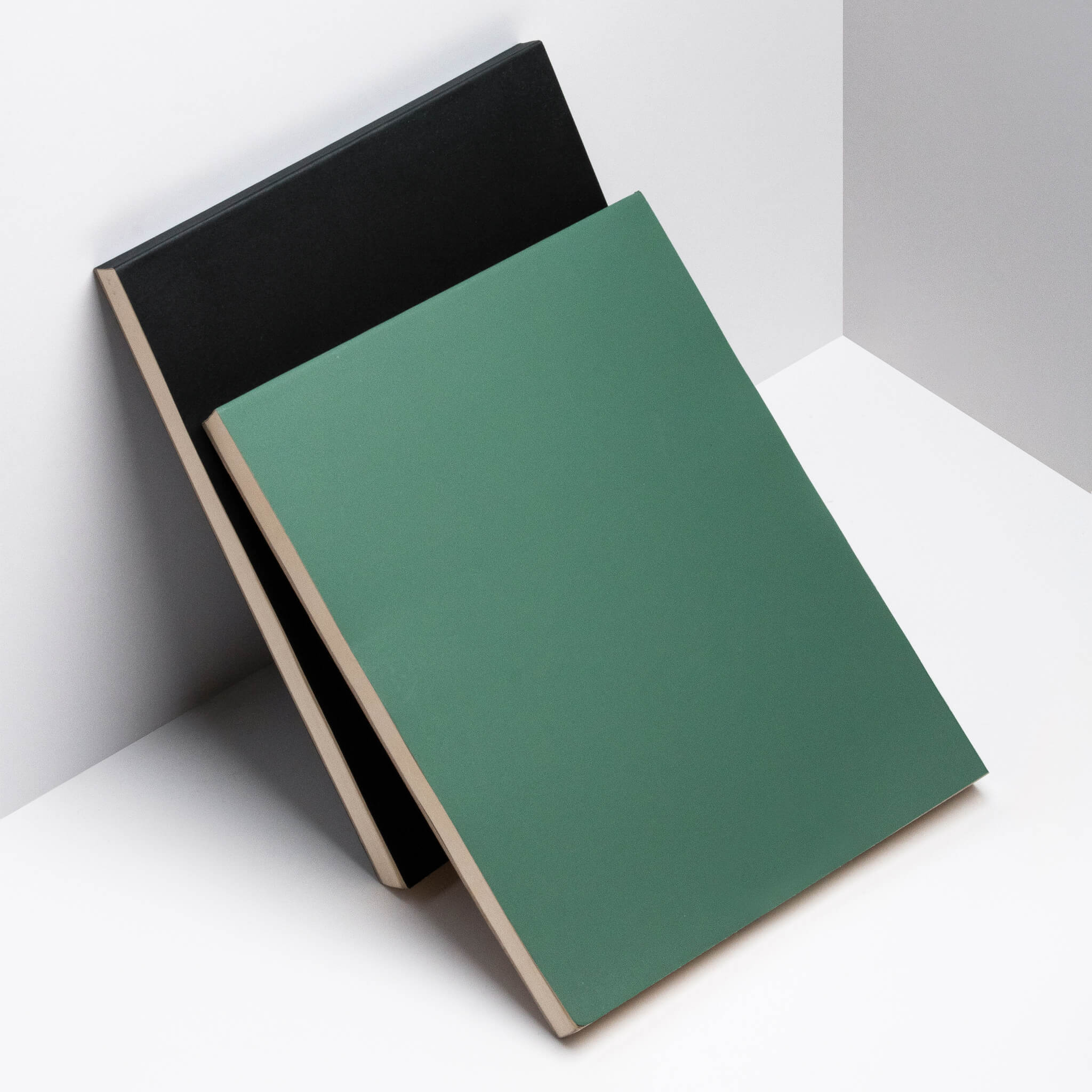 basenotes 2721 notebook collection showing green and black softcovers in a minimalist layout.