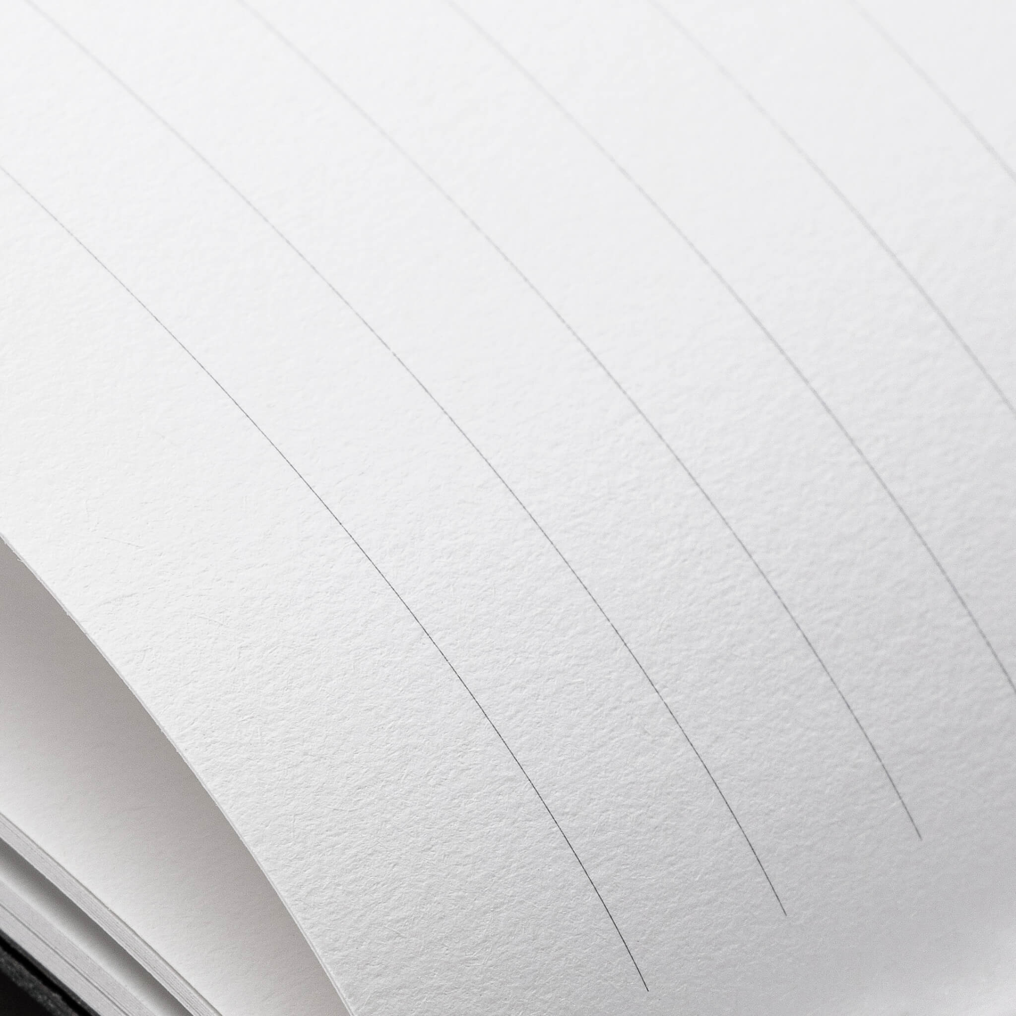 Macro view of basenotes 4000 A5 Notebook’s acid-free lined paper, revealing smooth surface ideal for everyday writing.