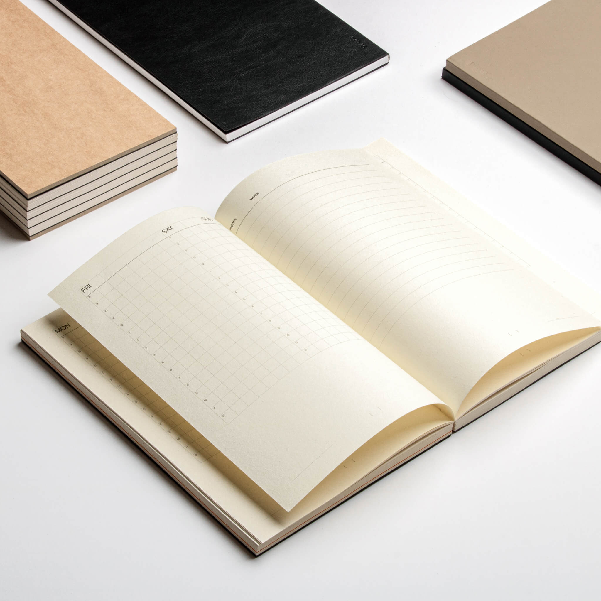 Open view of the basenotes Planner showing grid and lined weekly layouts, crafted on smooth FSC-certified pages.