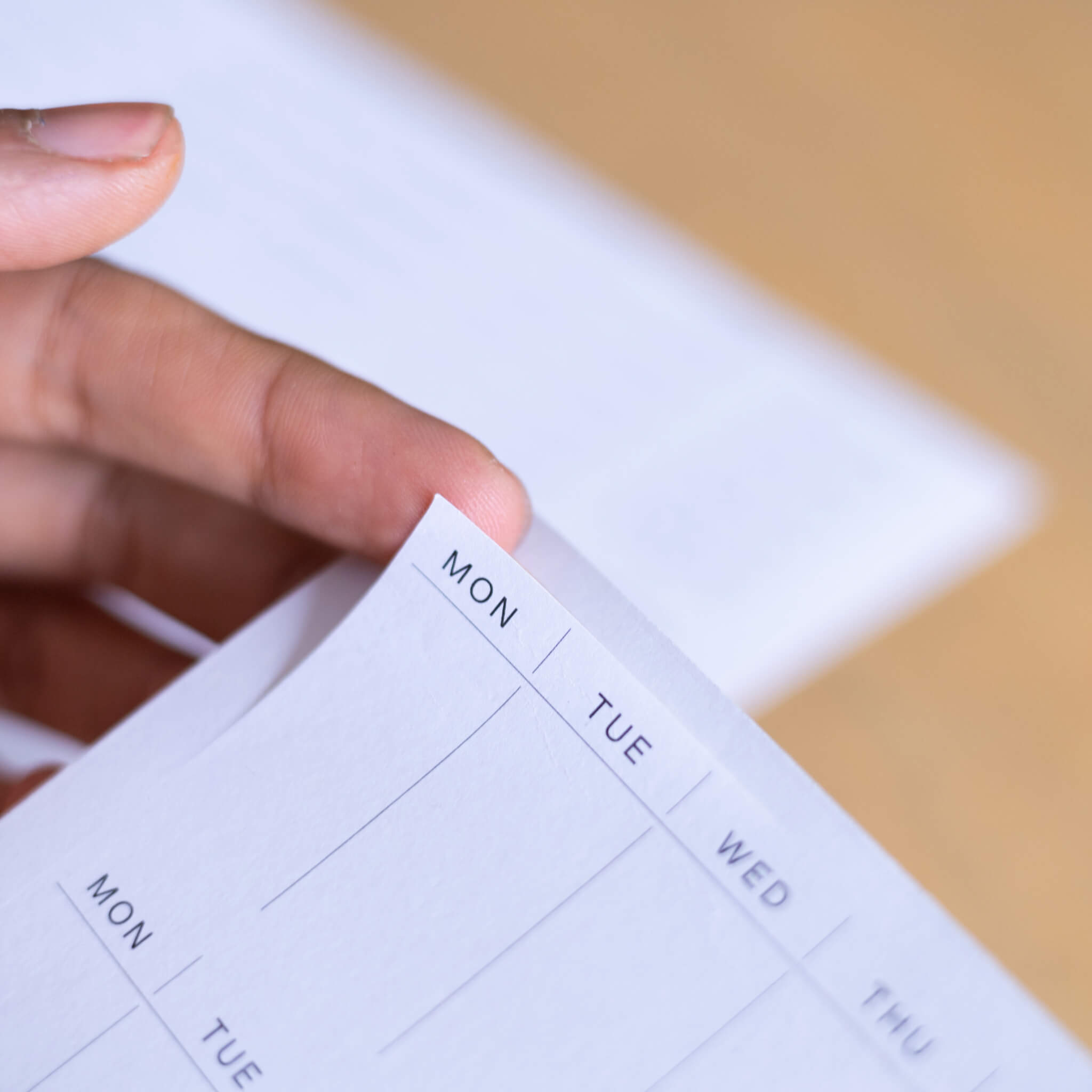 Close-up of a weekly planner page with weekday headers and clean layout