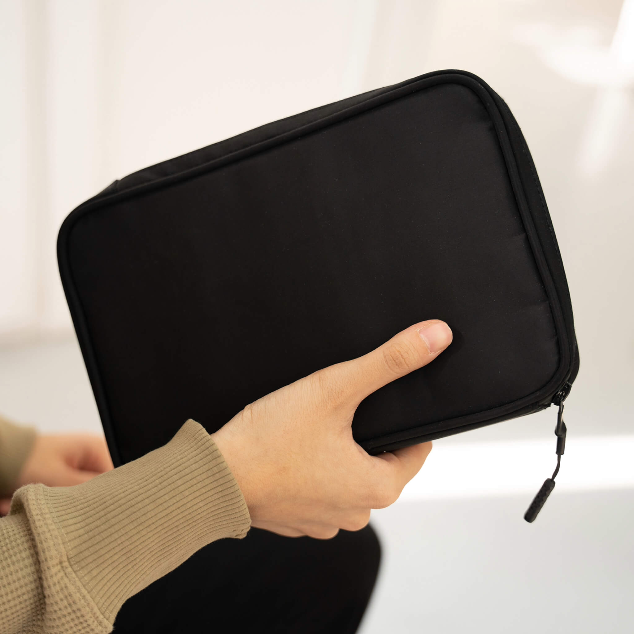 basenotes waterproof black notebook cover held in hand, minimal design