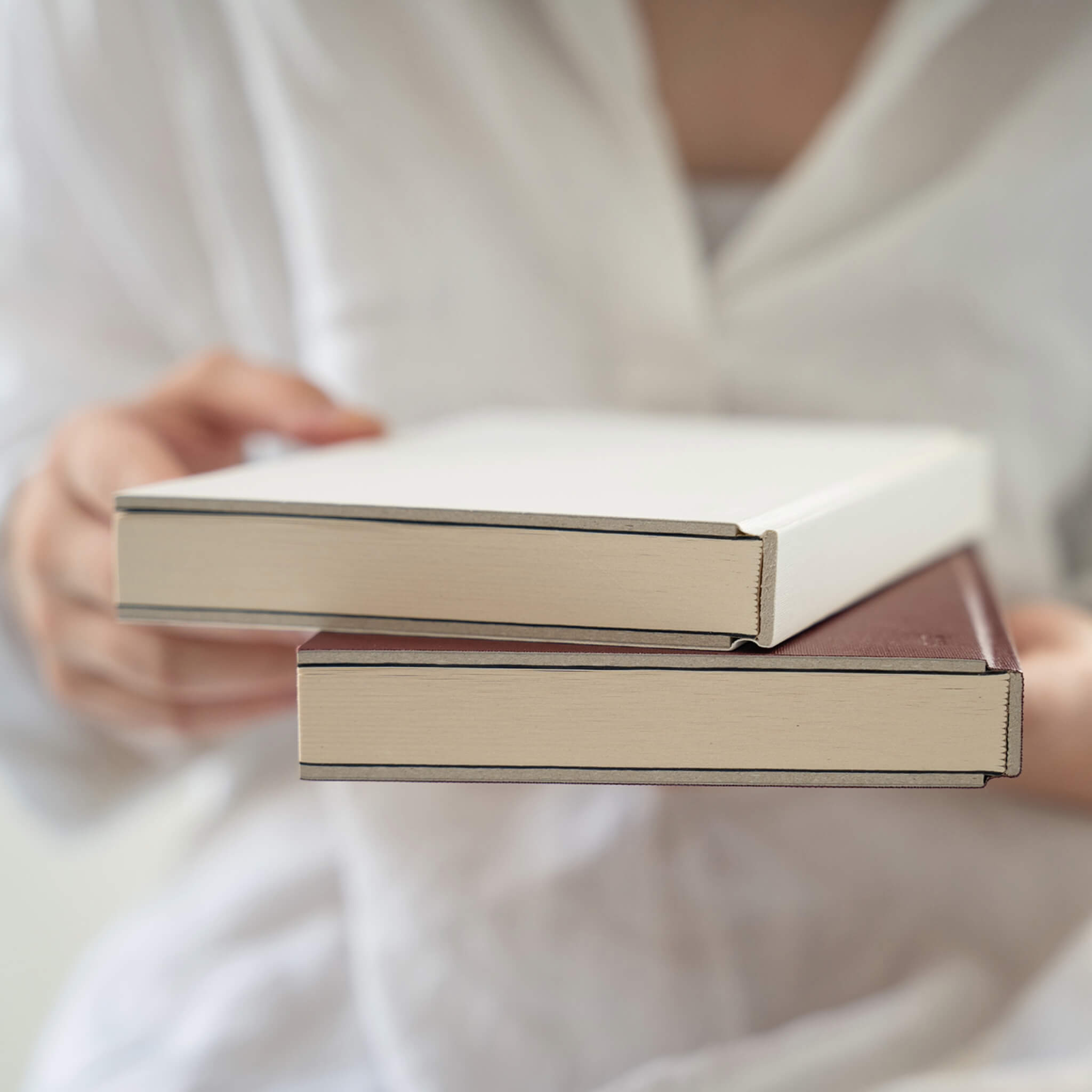 Close-up of basenotes 0128 Notebook edges in maroon and white, showing fine craftsmanship and clean binding.