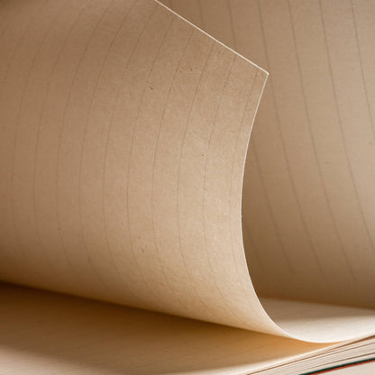 Detailed macro shot of basenotes 0144 notebook’s paper pages, showing soft natural tone and fine texture.