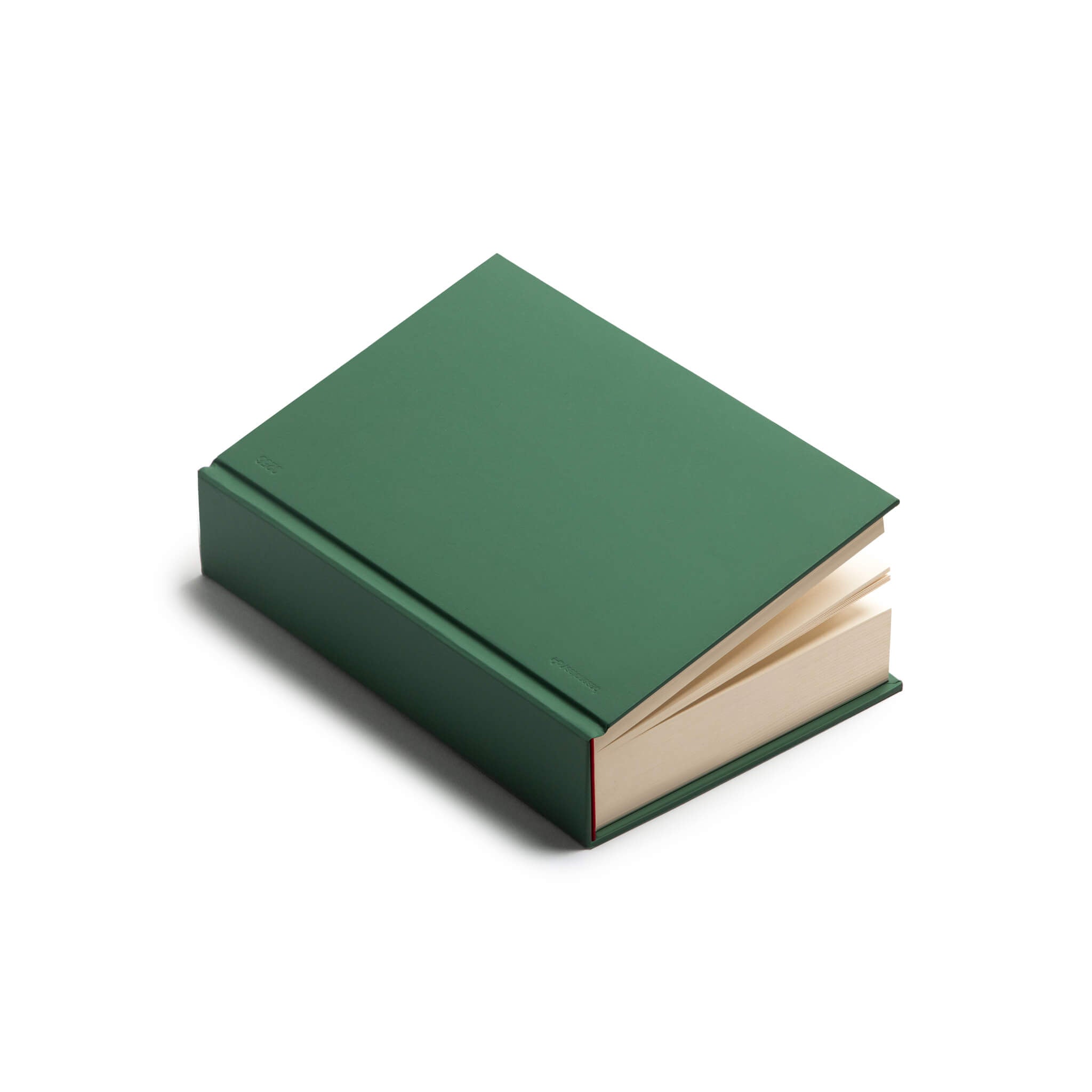 Green basenotes 0256 Notebook photographed closed, showing smooth hardcover texture and red spine detail.