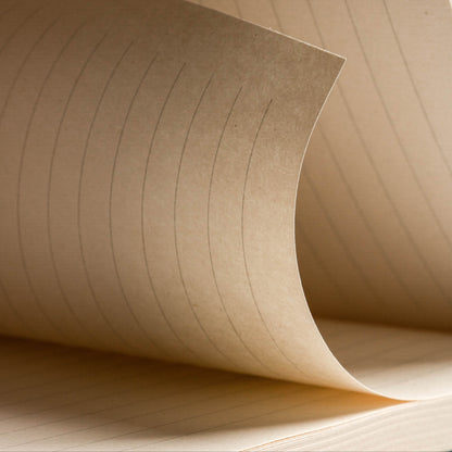 Detailed view of brown ruled pages from the basenotes 0432 Notebook, emphasising texture and line spacing.