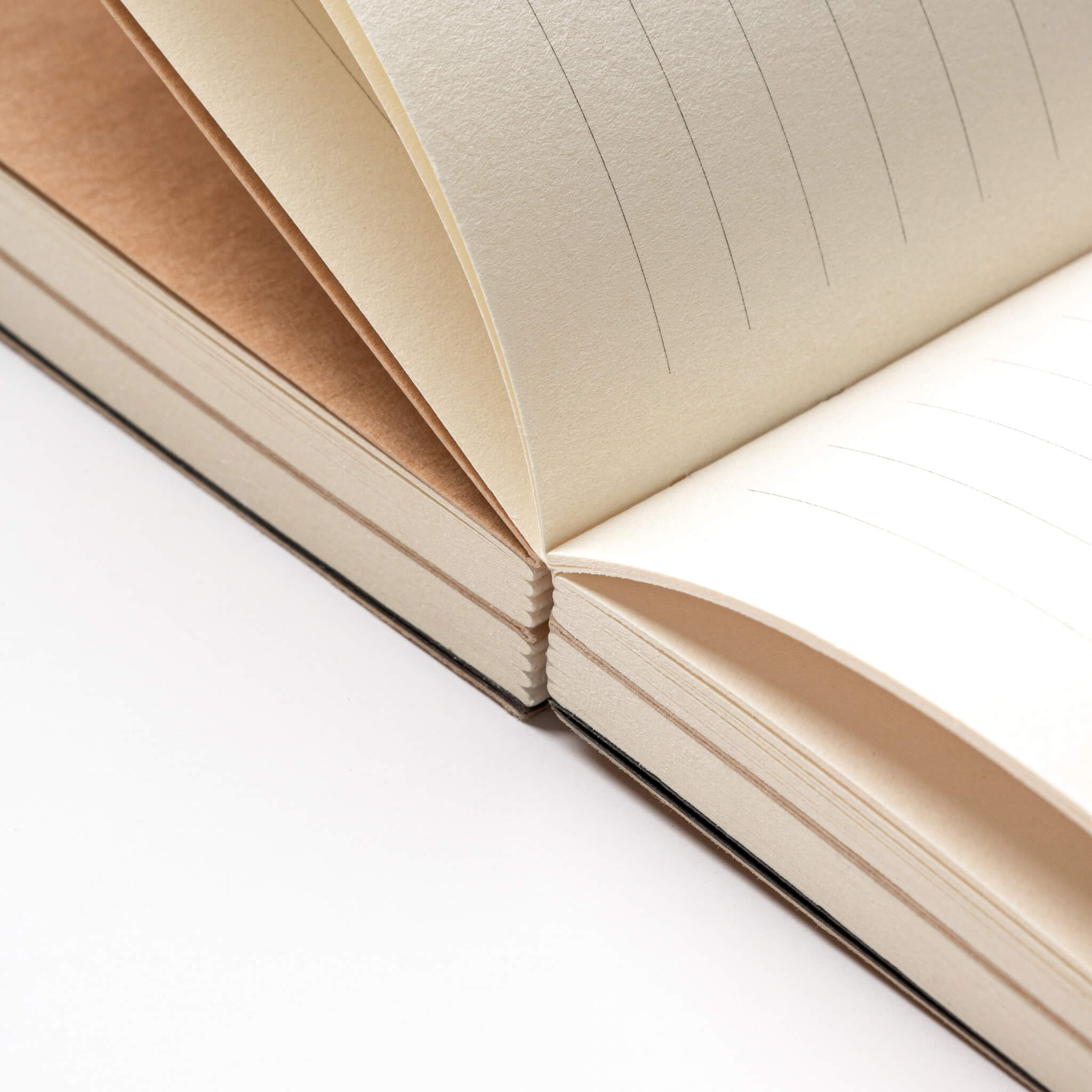 Close-up of the kraft cover and edge of the basenotes 0432 Notebook, showing layered paper sections.