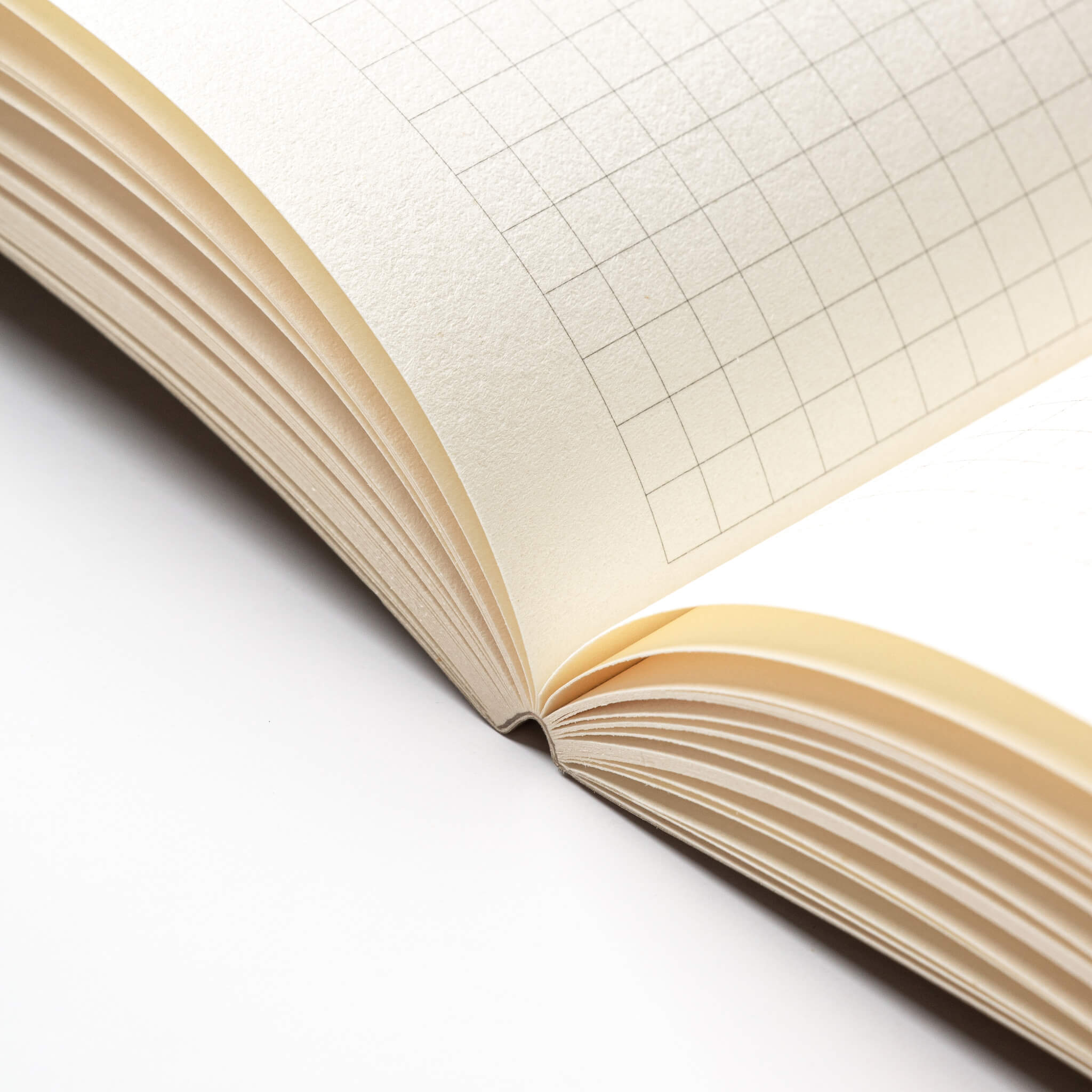 basenotes 0480-A5 Notebook open flat, showcasing smooth lay-flat binding and grid paper pages.