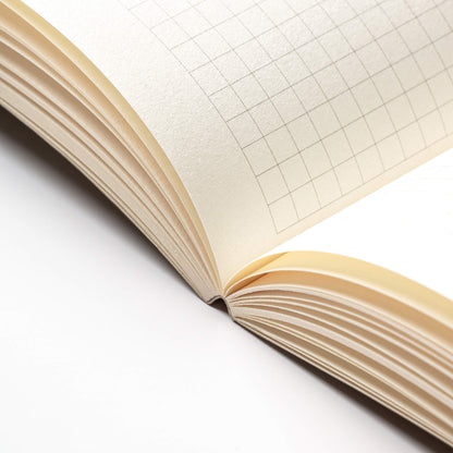 basenotes 0480-A5 Notebook open flat, showcasing smooth lay-flat binding and grid paper pages.