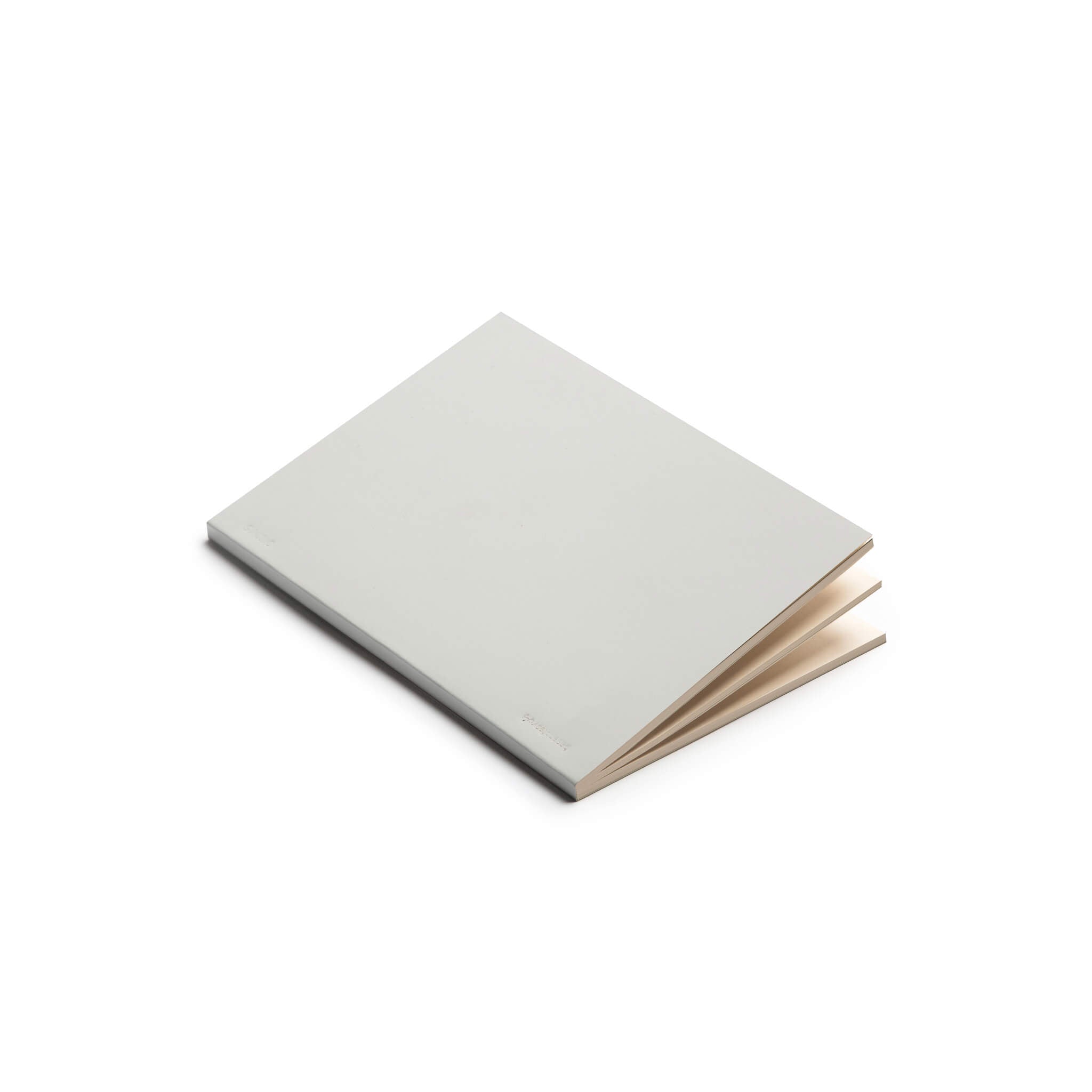 basenotes 0480 Notebook with grey cover, opened slightly to reveal cream paper pages.