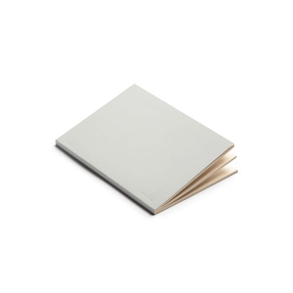 basenotes 0480 Notebook with grey cover, opened slightly to reveal cream paper pages.
