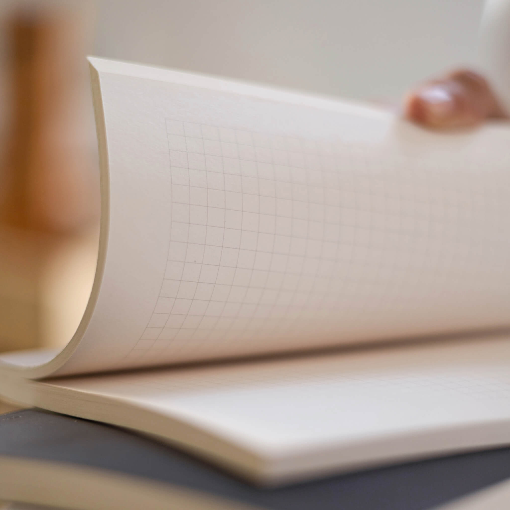 Close-up of basenotes 0480 Notebook grid paper highlighting smooth, acid-free pages and fine printed lines.