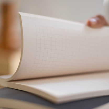 Close-up of basenotes 0480 Notebook grid paper highlighting smooth, acid-free pages and fine printed lines.