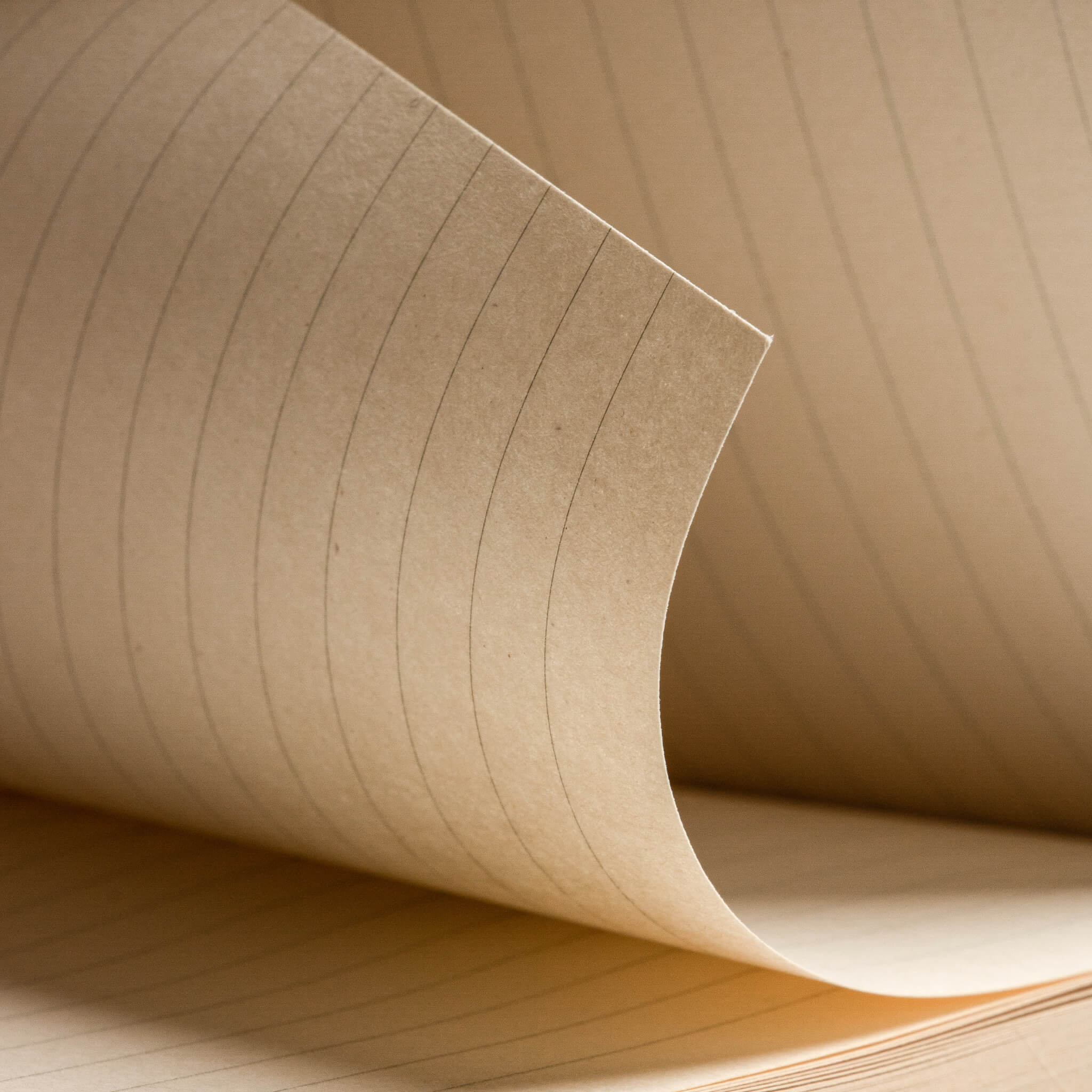 Detailed shot of basenotes 0880 Notebook’s lined kraft paper showing fine printed lines and tactile surface.