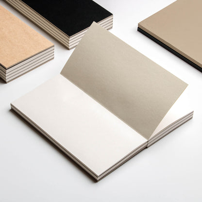 basenotes 1122 Paperbook open flat with Beige cover, surrounded by Black and Kraft variants
