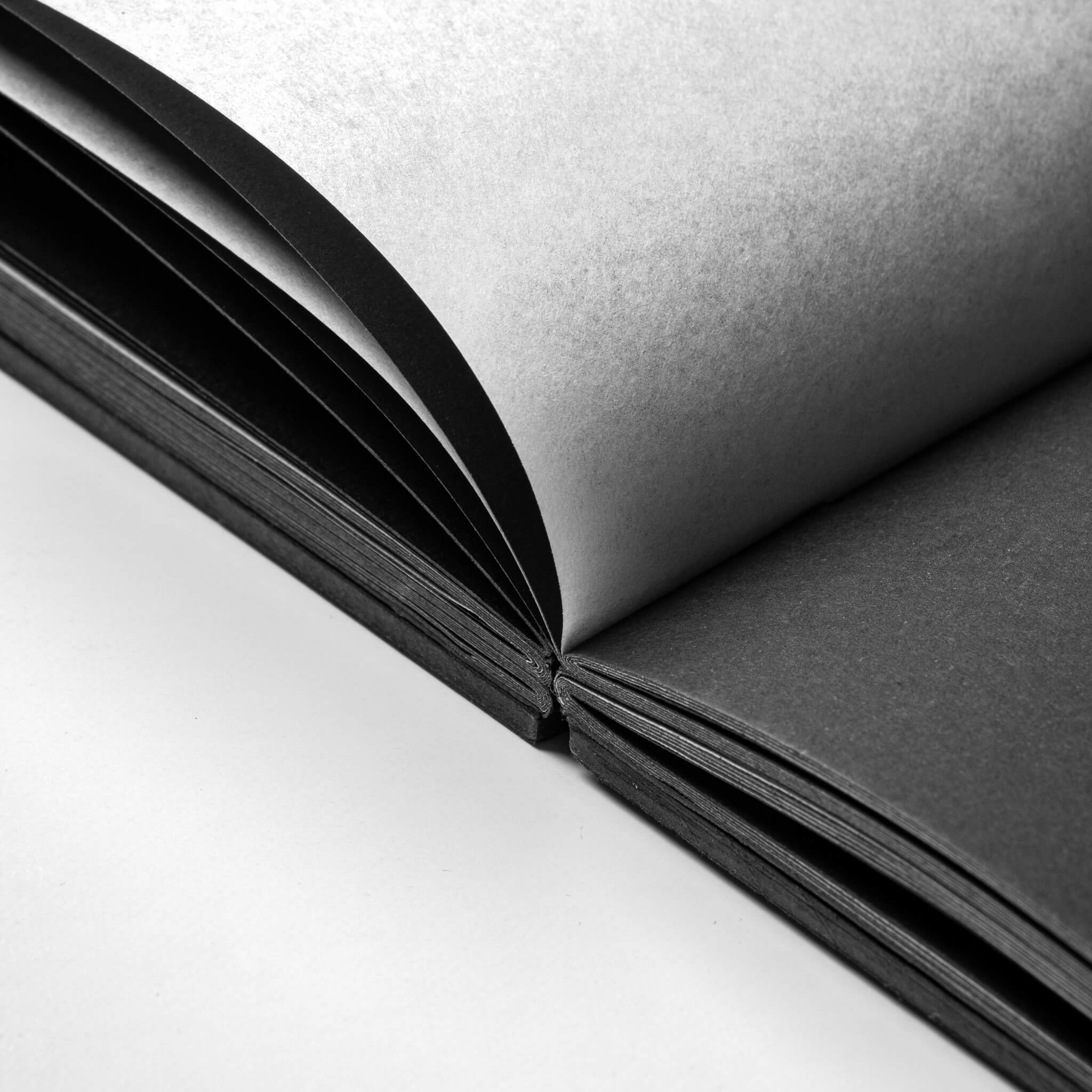 basenotes 1623B Black Paper book opened flat to show black pages and interleaved tracing paper.