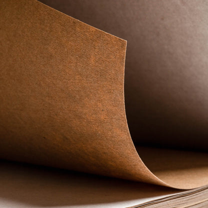 Close-up of kraft paper texture inside the basenotes 1623K Paper book, showing smooth and natural brown surface.