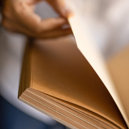 basenotes 1623K Kraft Paper book mid-page turn showing brown kraft and tracing paper layers.