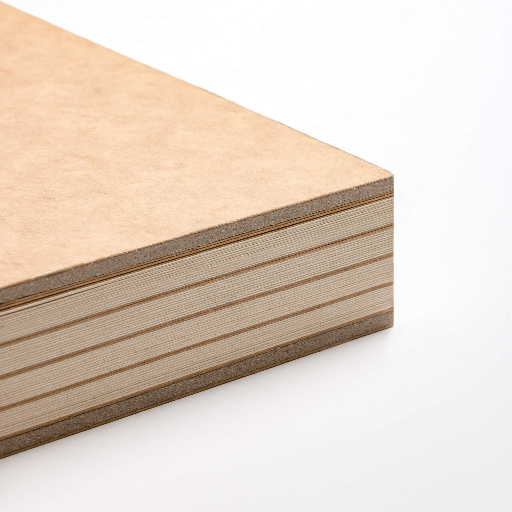 Corner detail of the basenotes 2316 kraft sketchbook showing its durable handmade spine and smooth paper edge.