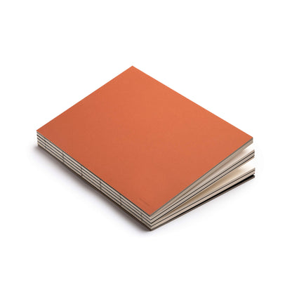 basenotes 2333 Clay Rust Paperbook featuring an earthy orange-brown cover and exposed hand-stitched binding.