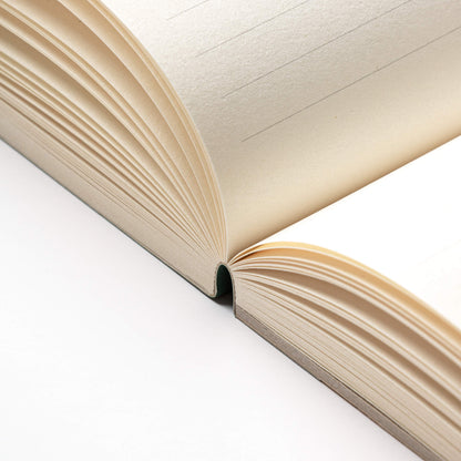 Open basenotes 2721 notebook showing hand-stitched lay-flat binding and clean FSC-certified paper.