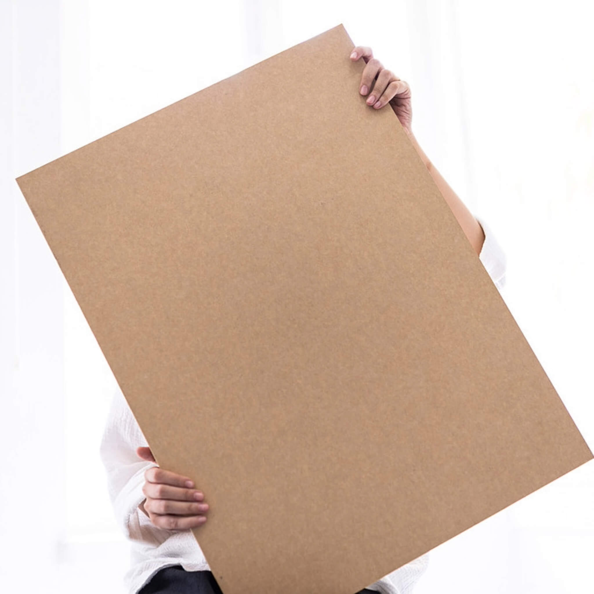 basenotes 35x55 cm sketchbook with kraft cover, shown in hand to highlight size and minimalist design.