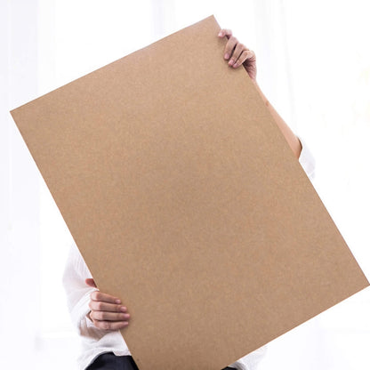 basenotes 35x55 cm sketchbook with kraft cover, shown in hand to highlight size and minimalist design.