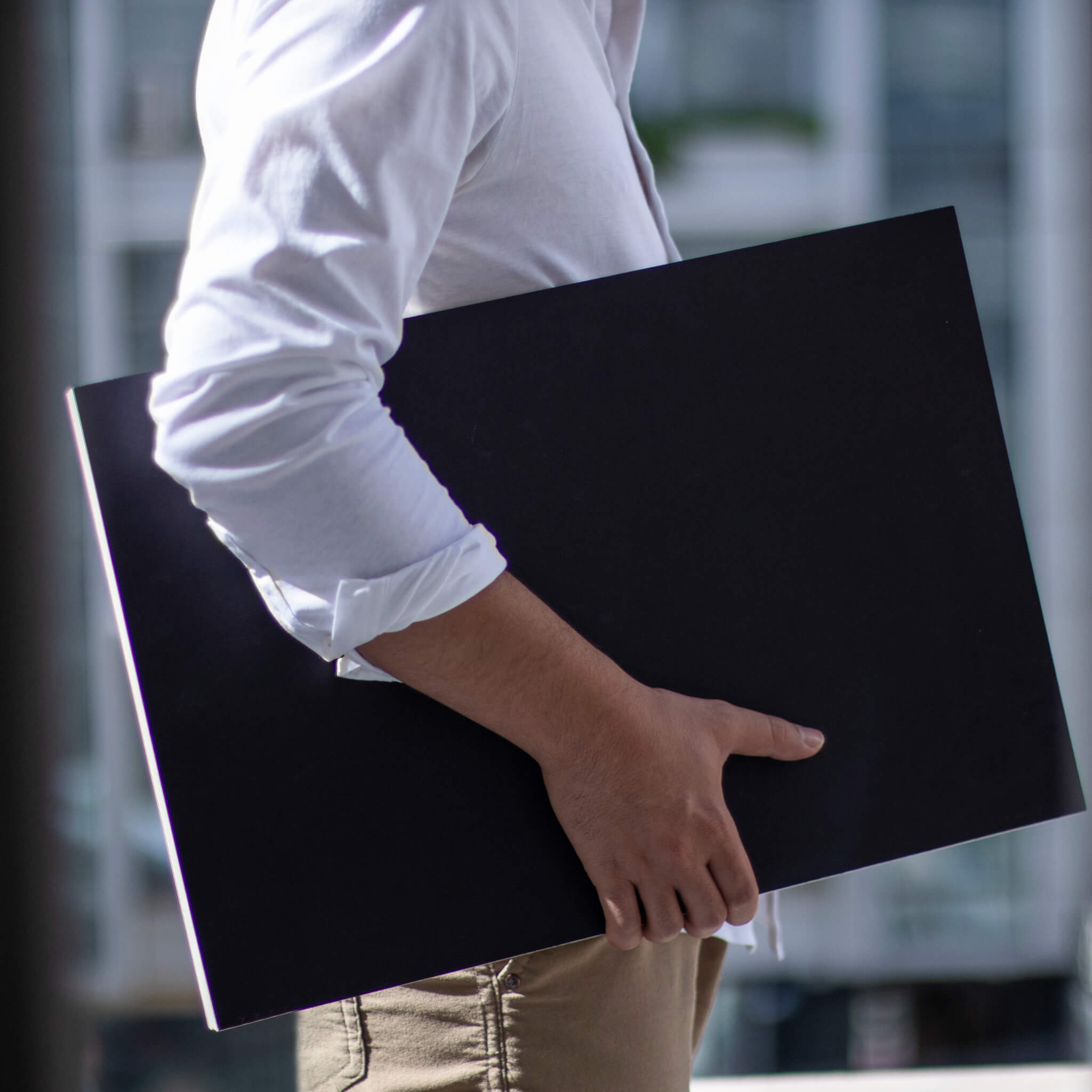 basenotes 35x55 cm large sketchbook with a black cover, shown in hand to highlight scale and size for professional artists.
