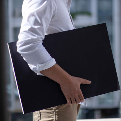 basenotes 35x55 cm large sketchbook with a black cover, shown in hand to highlight scale and size for professional artists.