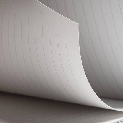 Close-up of basenotes 4000 A5 Notebook’s lined paper showing even spacing and fine texture suitable for pen and rollerball use.