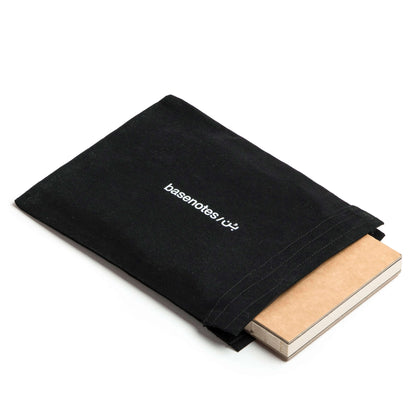 basenotes A5 black fabric notebook cover with notebook partially inside on white background