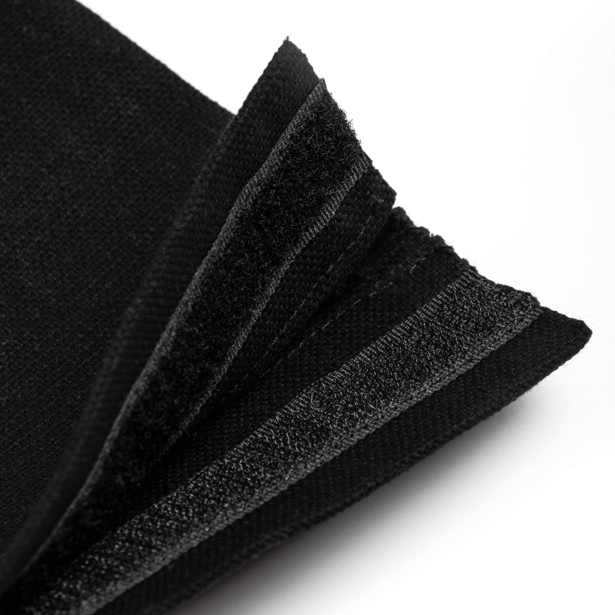 Close-up detail of basenotes black fabric notebook cover closure and stitching