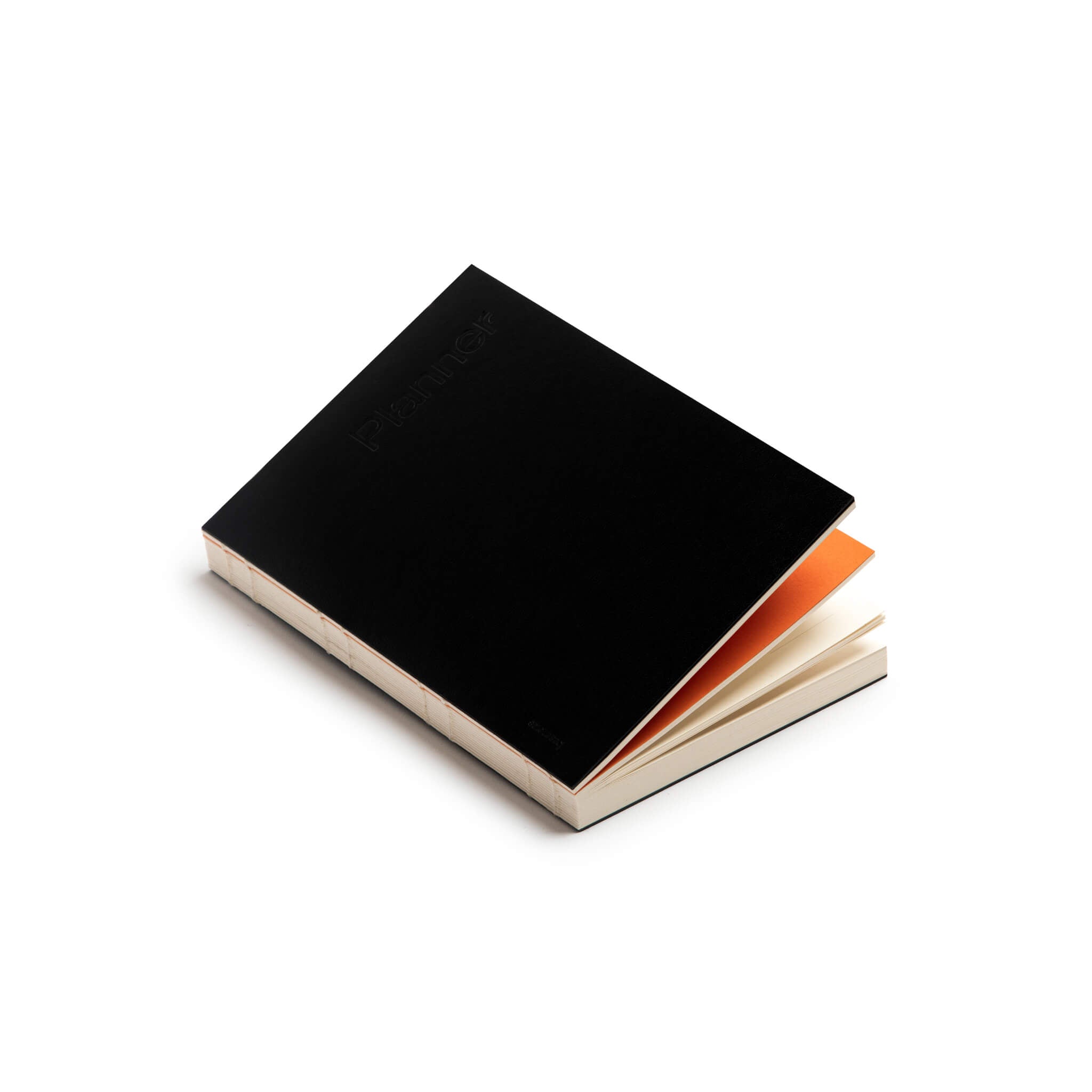 basenotes Planner with black cover and orange divider, featuring exposed spine stitching and FSC-certified cream pages in a lay-flat design.