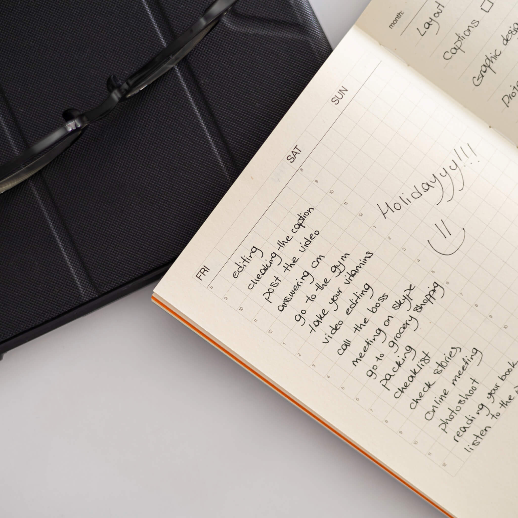 Flat-lay of the basenotes Planner weekly layout with handwritten notes and grid pages ideal for structured scheduling and journalling.