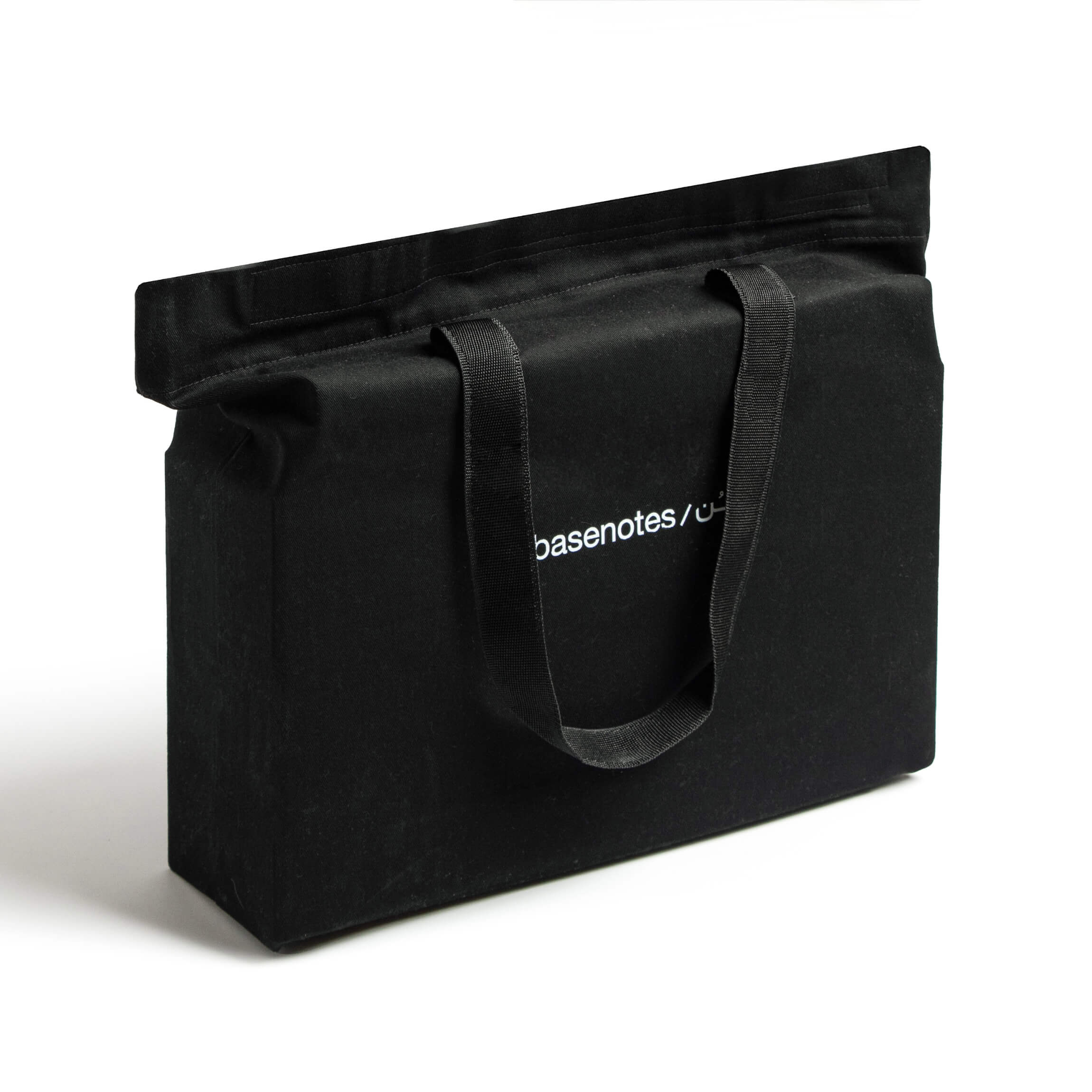 basenotes premium black fabric tote bag standing upright, minimalist product view