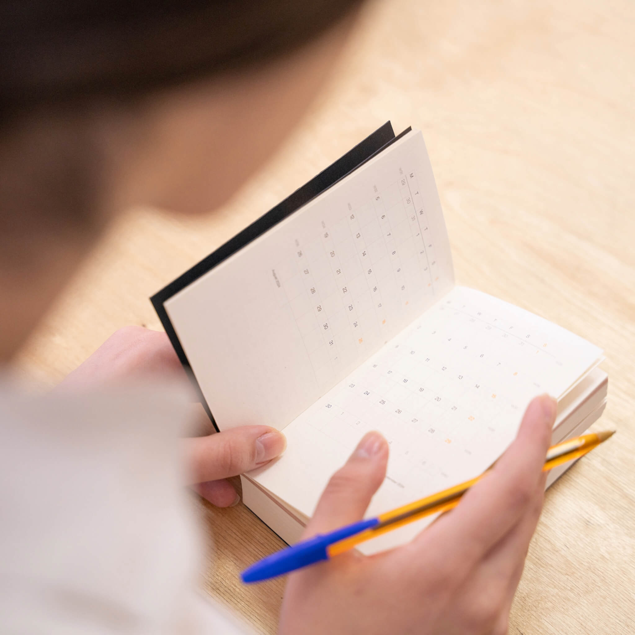 basenotes Tracker Notebook open to the monthly calendar section, ideal for planning and scheduling.