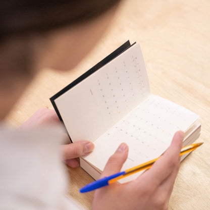 basenotes Tracker Notebook open to the monthly calendar section, ideal for planning and scheduling.