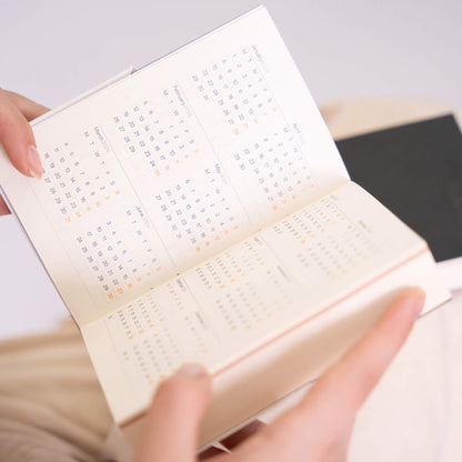basenotes Tracker Notebook showing yearly overview pages with neatly printed calendar layout.