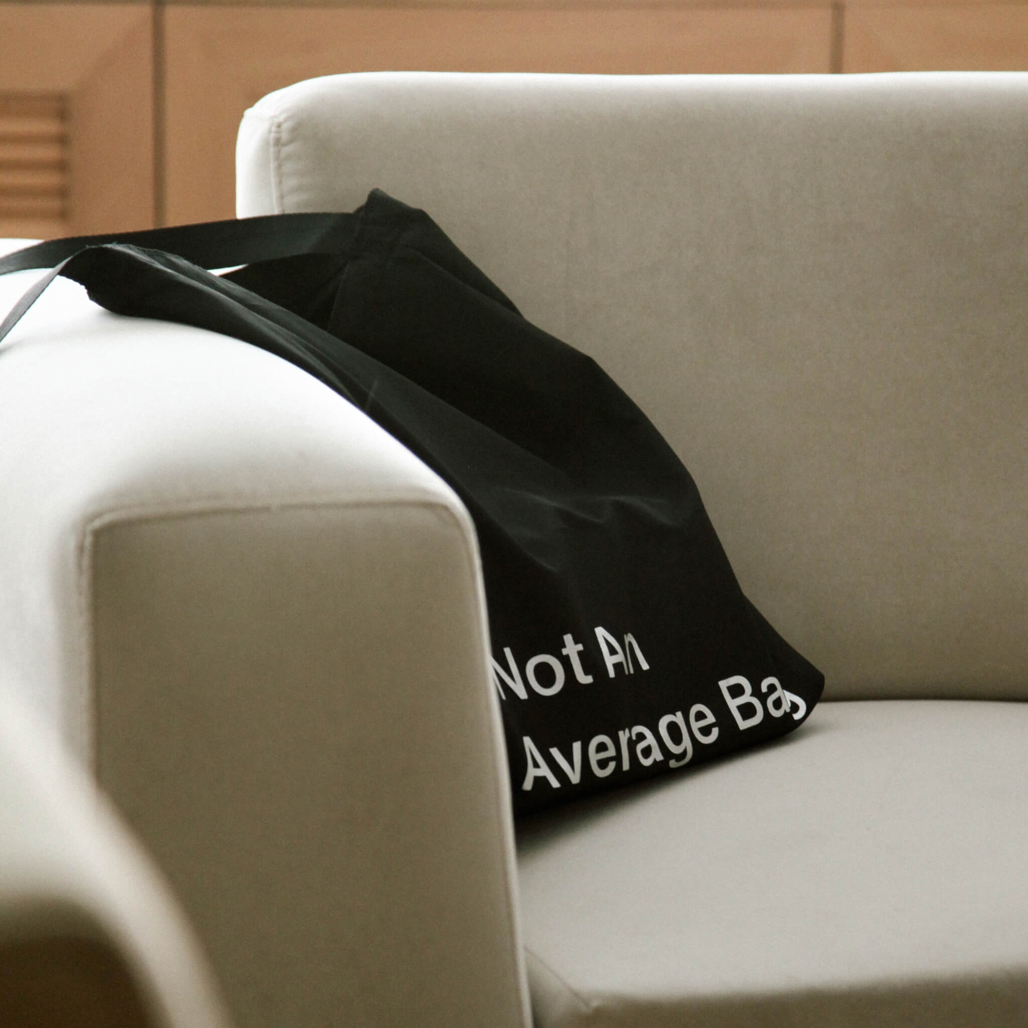 basenotes waterproof black tote bag resting indoors, relaxed everyday lifestyle view