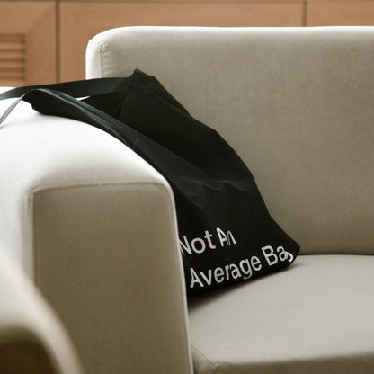 basenotes waterproof black tote bag resting indoors, relaxed everyday lifestyle view