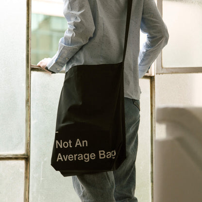 basenotes waterproof utility tote worn on the shoulder in a modern lifestyle setting