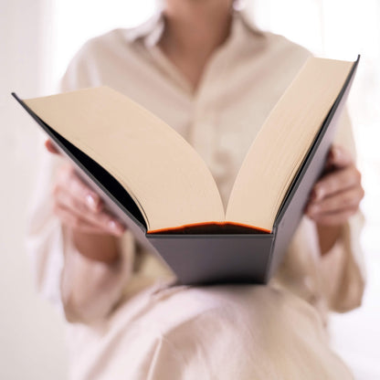 Open basenotes 0512 Notebook resting on a lap, showing its lay-flat binding and smooth bulky paper ideal for long-form journaling.